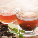 Hot tea of cup with slice of lemon on hemp sack for break fast and drinking time in morning